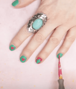 pink heart on green nail